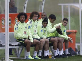 Brazilian players, from left, Marcelo, David Luiz, Neymar, Fernandinho, Thiago Silva, and Oscar, sit on the bench during a training session. (Andre Penner/AP)