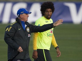 Brazil's coach Luiz Felipe Scolari, left, gives instructions to his player Dante during a practice session at the Granja Comary training center, in Teresopolis, Brazil, Sunday, July 6, 2014. Brazil will face Germany  in their World Cup semifinals' match, without superstar soccer player Neymar. (AP Photo/Leo Correa)
