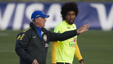 Brazil's coach Luiz Felipe Scolari, left, gives instructions to his player Dante during a practice session at the Granja Comary training center, in Teresopolis, Brazil, Sunday, July 6, 2014. Brazil will face Germany  in their World Cup semifinals' match, without superstar soccer player Neymar. (AP Photo/Leo Correa)