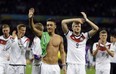 Germany's Mesut Ozil, left, and teammate Andre Schuerrle (9) celebrate after Germany defeated Algeria 2-1 in extra time during the World Cup round of 16 soccer match between Germany and Algeria at the Estadio Beira-Rio in Porto Alegre, Brazil, Monday, June 30, 2014. (AP Photo/Kirsty Wigglesworth)