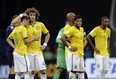 Brazil's David Luiz (L) and Oscar console each other alongside Hulk (C) and Fernandinho (R) after the Netherlands 3-0 victory over Brazil. (Natacha Pisarenko/AP)