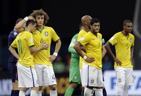 Brazil's David Luiz (L) and Oscar console each other alongside Hulk (C) and Fernandinho (R) after the Netherlands 3-0 victory over Brazil. (Natacha Pisarenko/AP)