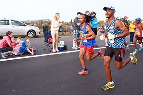 Spectators cheer runners as close to 16,000 competitors from South Africa and abroad run the Comrades Marathon from Pietermaritzburg to Durban on June 1, 2014.