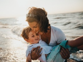 Mother and sun playing on the beach.