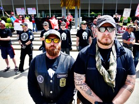 Beau Welling, left, and Greg Paul belong to an Alberta chapter of the armed militia group Three Percenters.
