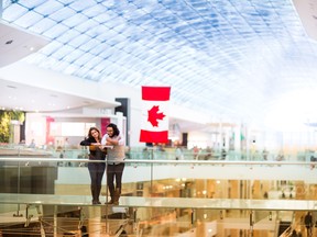 A couple stands in The Core Shopping Centre in Calgary