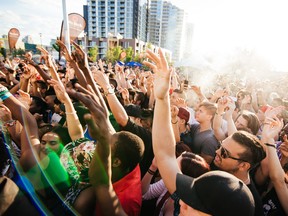 Fans have their arms in the air at the Sled Island Music Festival