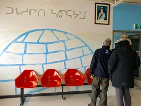 Wall art and a photo of the Queen spruce up an airport in Hall Beach, Nunavut. Photo by Jennifer Bain