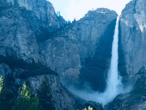 Waterfalls surge over cliff faces in Yosemite National Park in California.