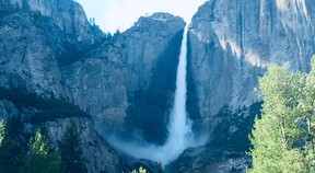 Waterfalls surge over cliff faces in Yosemite National Park in California.