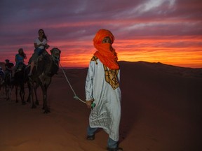 Going camel trekking (when it's cool out) and overnighting in the desert  is an essential Moroccan experience. [G Adventures]