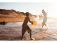 A boy plays on the beach at Prince Edward Island National park.