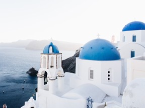 Santorini, Greece, with its whitewashed churches with blue domes.