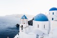 Santorini, Greece, with its whitewashed churches with blue domes.