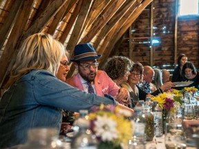 A group of people eat dinner at the Old Red Barn in Edmonton