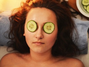 Woman relaxing at spa with cucumber slices