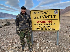 Jessie Ningiuk shows off this warning sign during a hamlet tour.