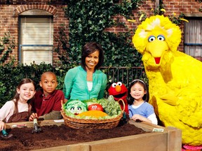 Michelle Obama with the Sesame Street cast.