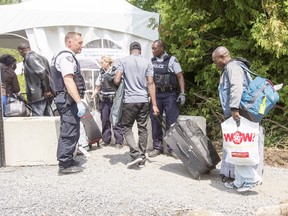 A group of asylum seekers cross the Canadian border at Champlain, N.Y.