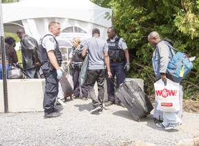 A group of asylum seekers cross the Canadian border at Champlain, N.Y.