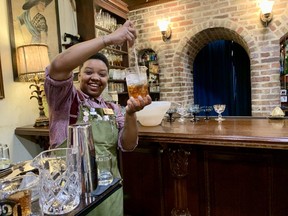 During a cocktail class at Congress Street Up in the American Prohibition Museum, Tiffani Williams demonstrates how to properly stir a cocktail.