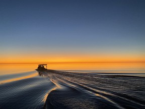 A clam boat heads out in the early morning in Cedar Key, Florida.