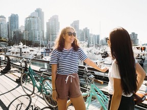 Women bike on the Stanley Park Seawall in Vancouver