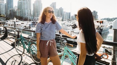 Women bike on the Stanley Park Seawall in Vancouver