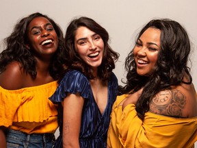 Three women smiling and laughing