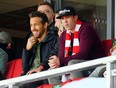 Wrexham AFC owners Ryan Reynolds and Rob McElhenney take in a match.