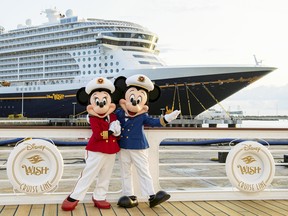 Minnie and Mickey Mouse welcome passengers to the Disney Wish in Port Canaveral, Florida.