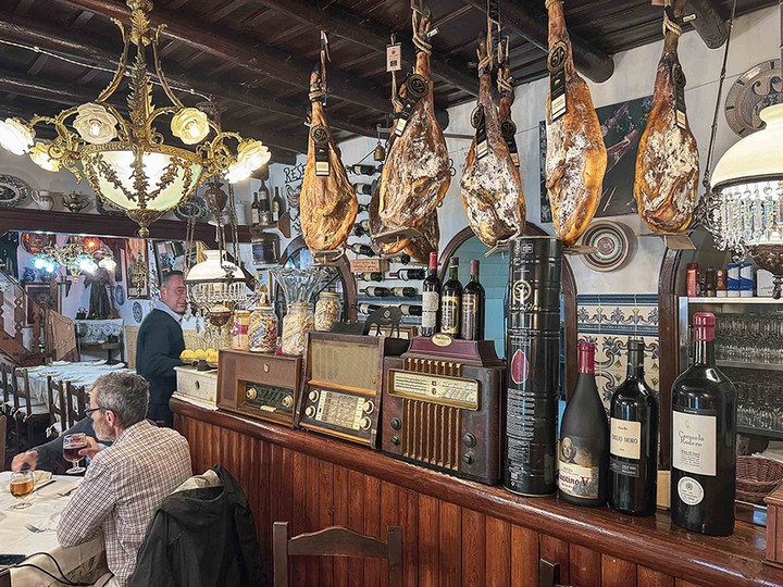  Ham legs hanging from the ceiling in Casas Restaurant in the village of Aracena.