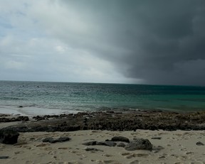 My boyfriend was innocently snorkelling on the left under sunny skies as the storm clouds make their way overhead.