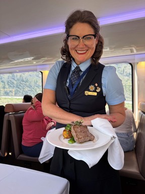 An image of Tina Mohns, a cabin host on the Rocky Mountaineer train serving lunch.