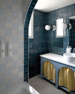 The bathroom inside the deluxe corner king suite at South Beach features welcoming blue tilework.