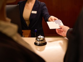A guest checking into a hotel at the front desk