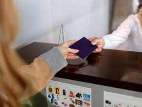 A passport being handed over at an airport