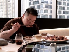 Toronto chef Eva Chin tucking into the sesame-skin suckling pig at Moon Bay.