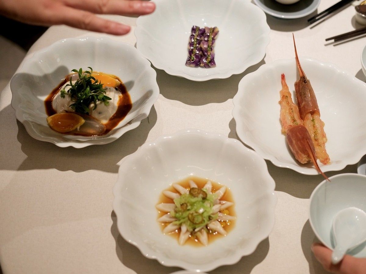 First courses at Wing included smoked eggplant with housemade sour sauce and chili; Japanese oysters topped with golden crystal egg; razor clams with Yunnan chili and bull kelp; and drunken botan shrimp.
