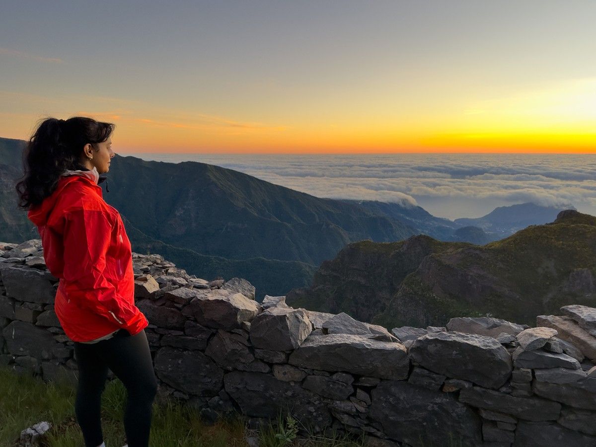 Morning light illuminates the cloud layer viewed from a lookout below Pico do Arieiro's summit.