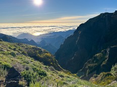 Sunlight highlights the deep valleys and peaks of Madeira's mountainous interior.
