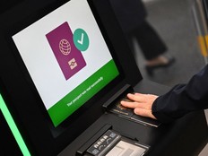 A person has their passport scanned whilst using an automated European Union Entry/Exit System kiosk.