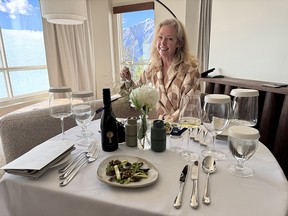 Writer Jody Robbins samples the wine while dining in her robe.