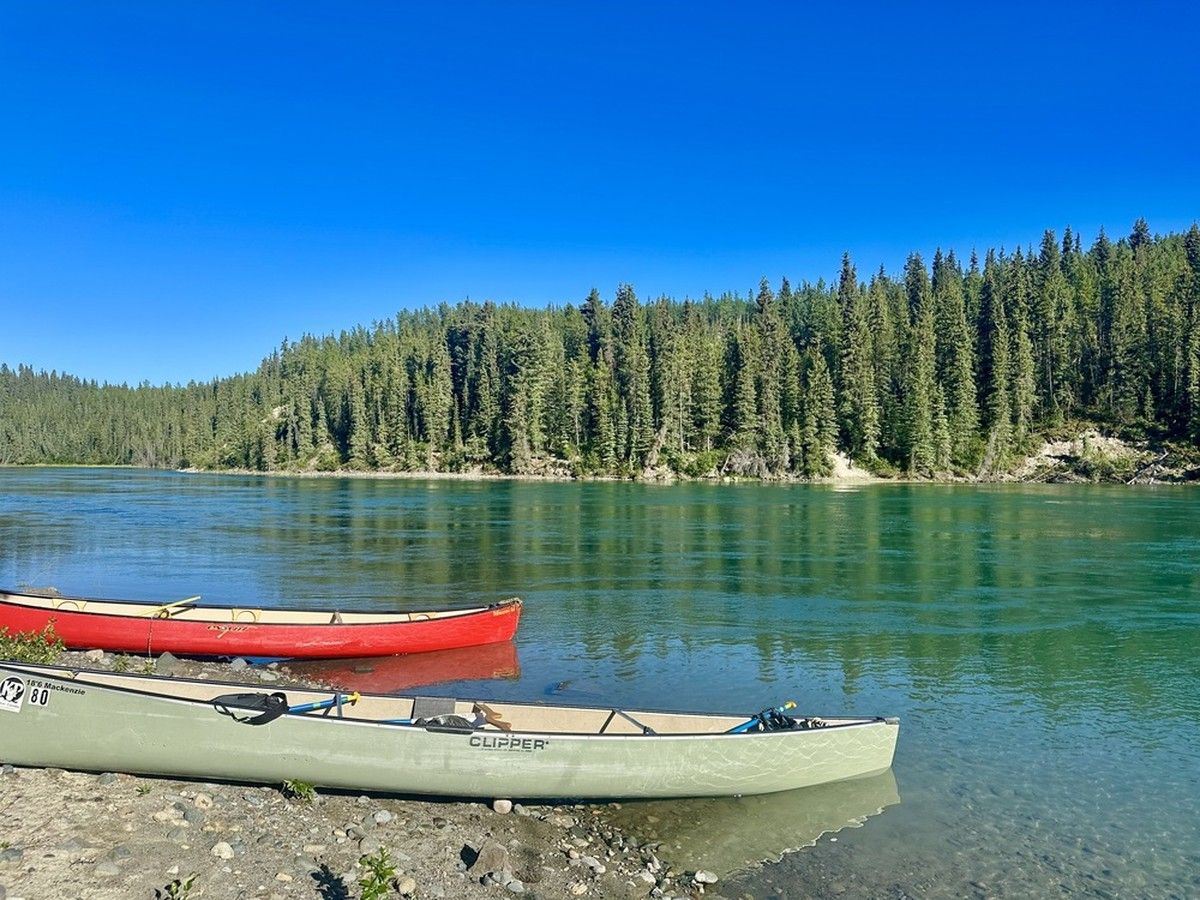 An evening paddle along the Yukon River with Kanoe People looks different under a bright blue sky.