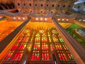 Warm sunlight glows through Sagrada Família's stained-glass windows.