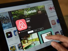 This file photo taken on April 28, 2016 shows a woman browsing the site of US home sharing giant Airbnb on a tablet in Berlin on April 28, 2016.