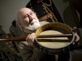 Alec Somerville at the Canadian War Museum Tuesday, with the mysterious banjo from the First World War. (Photo by Ashley Fraser,  Ottawa Citizen)