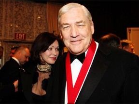 Conrad Black, with wife Barbara Amiel in the background, at the Politics and the Pen literary dinner held at the Fairmont Chateau Laurier on Wednesday, March 6, 2013.