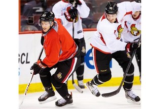 Mike Hoffman, left, battles with Jim O’Brien in a drill after he was called up from Binghamton last March.