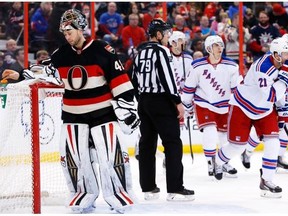 Ottawa’s Craig Anderson reacts to New York’s third goal on him as the Rangers celebrate during action between the Ottawa Senators and the New York Rangers Saturday at Canadian Tire Centre. New York beat Ottawa 4-1.